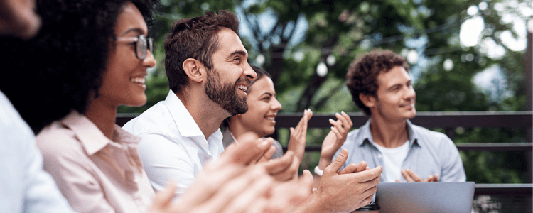 Group of coworkers smiling and chatting at a retreat